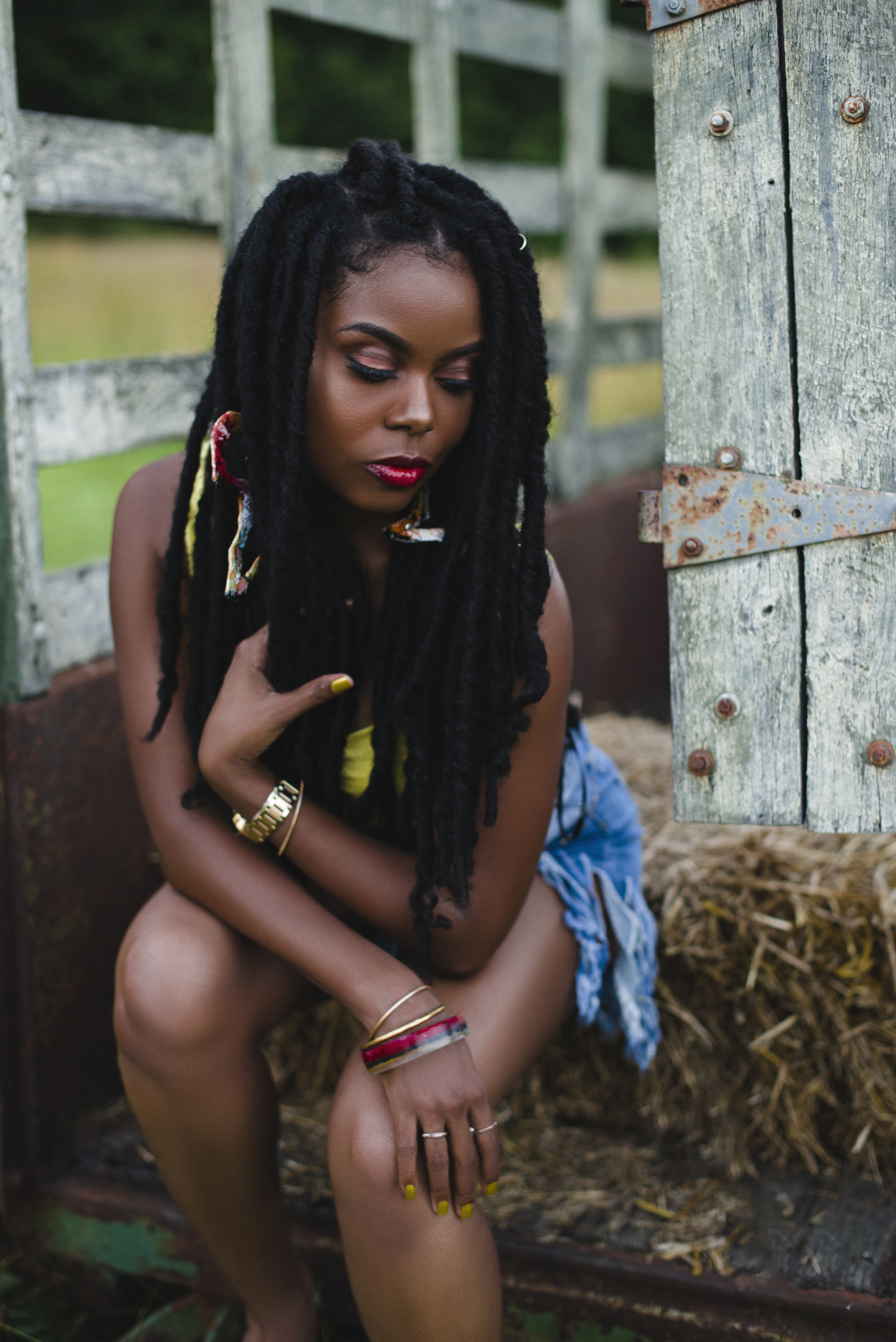 A quiet, close moment among hay bales and weathered wood